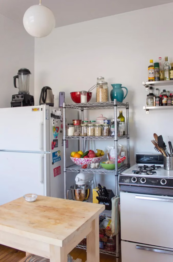 a small kitchen kept tidy by a metro rack in an organized and decluttered kitchen
