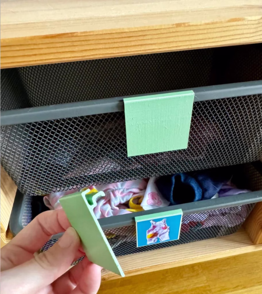 a professional organizer using 3D printed label holders to organize toys in an Ikea trofast organization system
